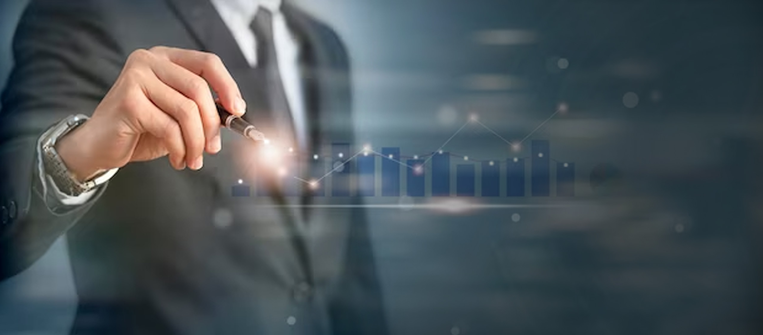 Businessman in a suit holding a pen and pointing to a rising bar and line chart overlay