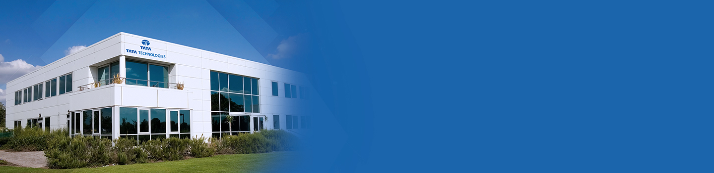 A modern white office building with Tata Technologies signage and the Tata logo on its facade under a blue sky