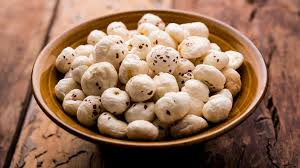 A bowl of makhana (fox nuts) on a rustic wooden surface