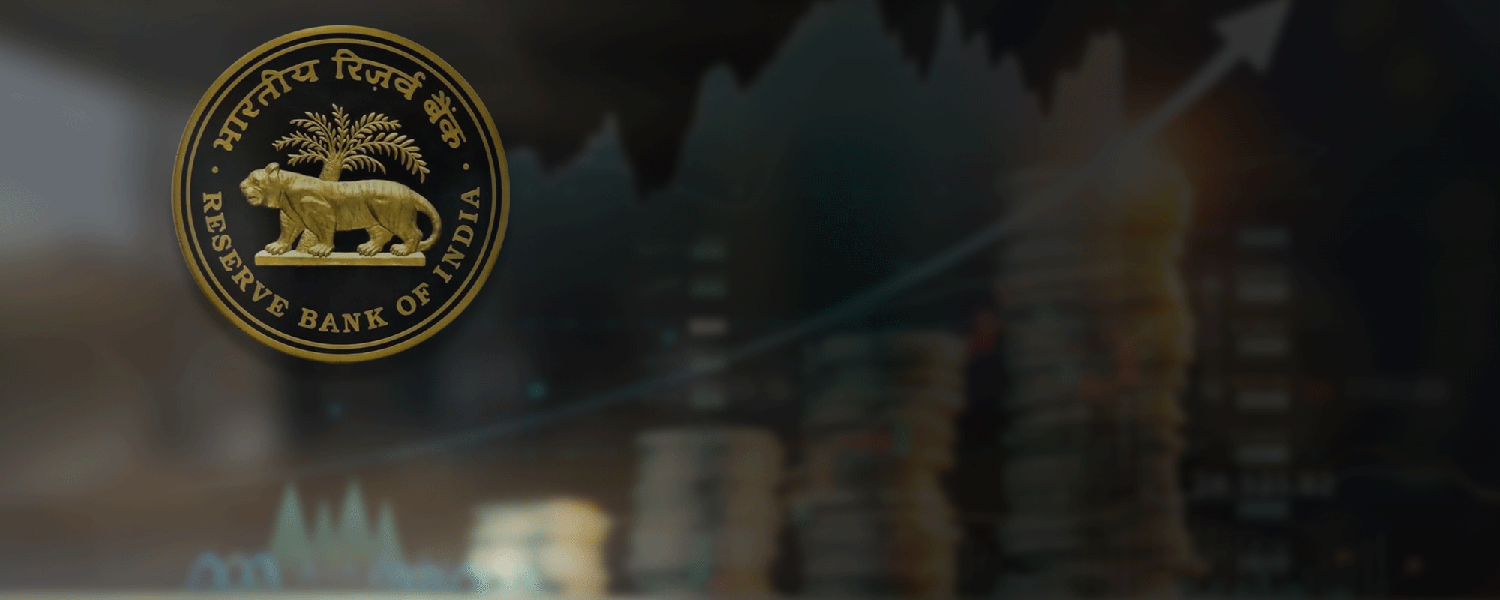 The gold Reserve Bank of India emblem over a dark, blurred backdrop of stacked coins and a rising line graph