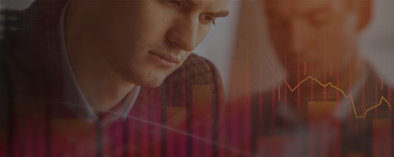 Two businessmen look down, overlaid with a red bar chart and a declining line graph