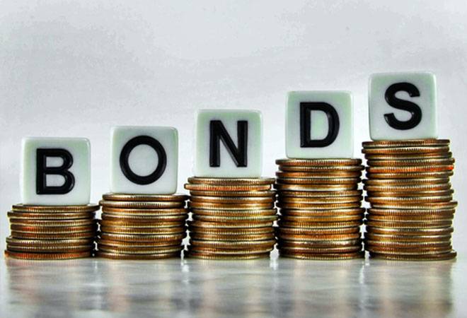 The word BONDS spelled in letter tiles atop five rising stacks of gold coins