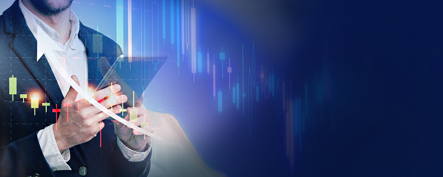 A businessman in a suit uses a tablet with overlaid candlestick charts and a rising arrow.